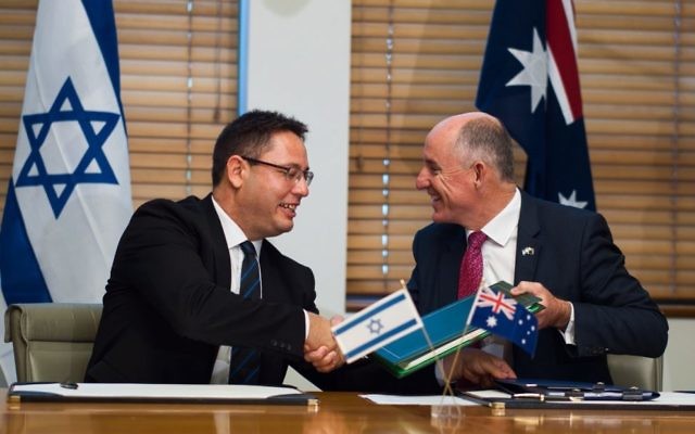Israeli deputy chief of mission Ron Gerstenfeld (left) and Australian assistant
treasurer Stuart Robert sign the deal. Photo: Twitter