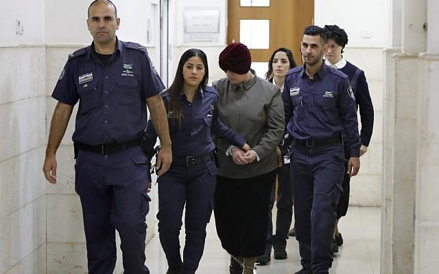 Malka Leifer is escorted by police as she arrives for a hearing at the District Court in Jerusalem, Feb. 27, 2018. Photo: Ahmad Gharabli/AFP/Getty Images