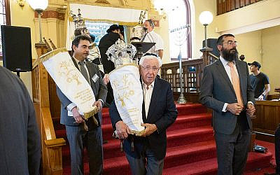 Frank Lowy carrying the Sefer Torah at the Siyum. Photos: Richard Weinstein