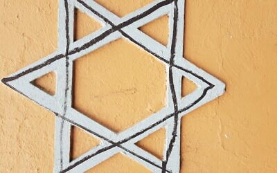 The Star of David defaced with a
black marker.