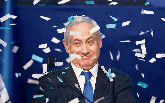 Israeli Prime Minister Benjamin Netanyahu in celebratory mood after the first exit poll results were released on
Monday evening. Photo: AP Photo/Ariel Schalit