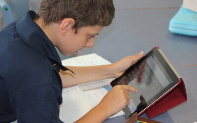 A Mount Sinai College student on their iPad.