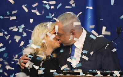 Benjamin Netanyahu kisses his wife Sara as exit polls predict a Likud victory.
Photo: AP Photo/Ariel Schalit