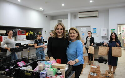 Lending a helping hand: Marina Makhlin and Stella Gankin with volunteers preparing Mother's Day care packages at Our Big Kitchen in Bondi.