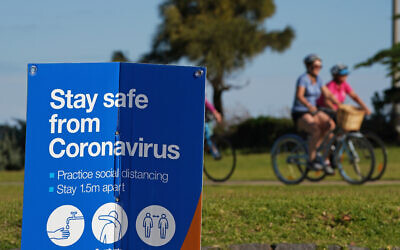 A coronavirus sign at Elwood beach. Photo: AAP Image/Scott Barbour