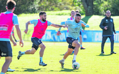 Jordi Swibel dribbles at pace during a recent Sydney FC training session, pursued by teammate Anthony Caceres.
Photo: Jaime Castaneda/Sydney FC