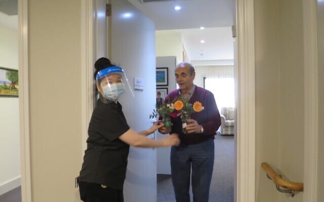 Arcare Caulfield resident Leo Bloumis receives his flowers as a result of the
Sponsor a Floral Posy Jar initiative.