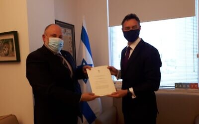 Paul Griffiths (right) presents copies of his credentials to Israeli Chief of State Protocol Meron Reuben.