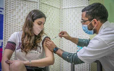 A woman receives a Covid-19 vaccine, at Clalit Covid-19 vaccination center in Rehovot, on January 4, 2021.  Photo by Yossi Aloni/Flash90