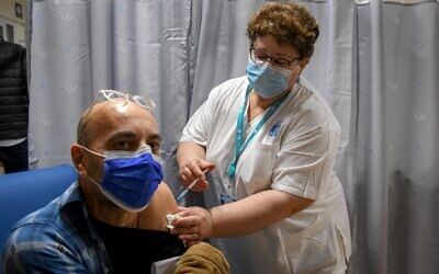 An Israeli teacher receives a COVID-19 vaccine, at the Shamir Medical Centre in Be’er Ya’akov. Photo: Avi Dishi/Flash90