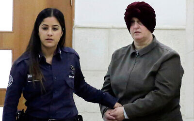 FILE - This Feb. 27, 2018 file photo, Australian Malka Leifer, right, is brought to a courtroom in Jerusalem. Leifer is wanted in Australia for 74 charges of sexual assault and the country's request for her extradition has been delayed for years. (AP Photo/Mahmoud Illean, File)