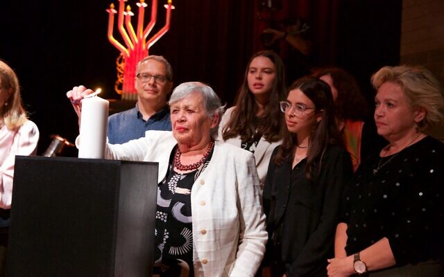Sofia Parij lights a candle with her family. Photo: Giselle Haber