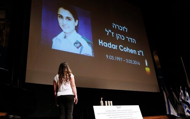 Orit Brand lights a candle for Hadar Cohen, an IDF soldier killed by terrorists
in Jerusalem. Photo: Peter Haskin