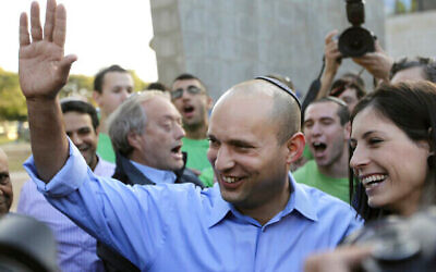 Naftali Bennett, head of Israel's Jewish Home party, left, waves to a crowd as he leaves a polling station after voting in Raanana, Israel, Tuesday, Jan. 22, 2013. Israelis began trickling into polling stations Tuesday morning to cast their votes in a parliamentary election expected to return Prime Minister Benjamin Netanyahu to office despite years of stalled peacemaking with the Palestinians and mounting economic troubles. (AP Photo/Ariel Schalit)
