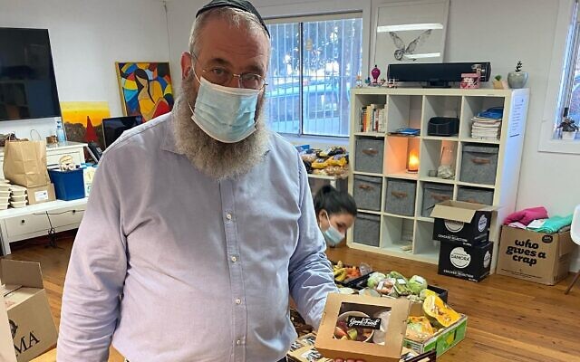 Jewish House CEO Rabbi Mendel
Kastel with client food packs.