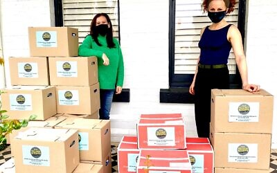 Our Village Kitchen’s Lisa Lipshut
(left) delivering Rosh Hashanah
boxes to Pathways’ Leah Bolton.