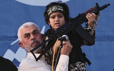 Hamas leader Yahya Sinwar holds the child of an Al-Qassam Brigades fighter, killed in the May 2021 conflict with Israel, during a rally in Gaza. 
Photo: Emmanuel Dunand/AFP