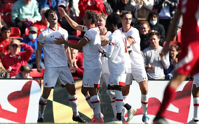 Ryan Blumberg (left) being congratulated by teammates after scoring in his US College debut on November 1 at Ludwig Field, Maryland. Photo: Zach Bland/Maryland Terrapins