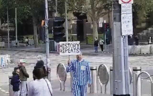 A man in a concentration camp uniform in Melbourne's CBD on Saturday. Photo: Screenshot
