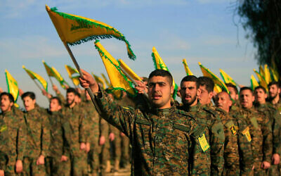 Hezbollah fighters holding flags. Photo: AP Photo