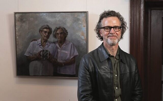 Winner Andrew Greensmith with his painting Two lives one soul, featuring Holocaust survivors Annetta Able and Stephanie Heller.