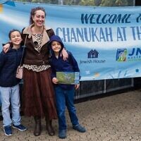 Akiva, Rachel and Levi Tanny enjoy Chanukah at the Zoo.