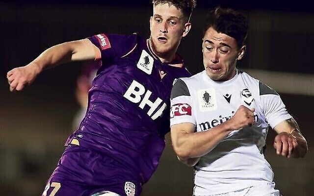 Jacob Muir (left) competes for the ball with Luis Lawrie-Lattanzio in an FFA Cup match in Adelaide on November 24. Photo: Kelly Barnes/Getty Images