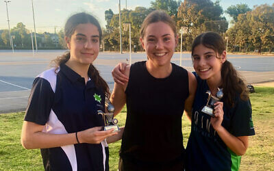 Jasmin Filer (left) and Mia Cashmore (right) receive their U15 Div 1 Spirit of Netball trophies from Maccabi coach Amy Rockman (centre).