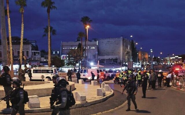Israeli police gather outside Damascus Gate after Saturday's attack. 
Photo: Ahmad Gharabli/AFP via Getty Images
