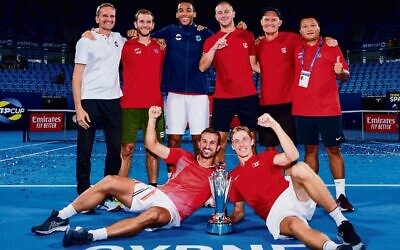 Denis Shapovalov (front on right) and his Canadian teammates celebrate winning the 2022 ATP Cup final in Sydney. Photo: Brett Hemmings/ATP