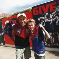 Elliot (left) and Dylan Swart outside their front fence in Caulfield after the Melbourne Football Club's historic grand final win. Elliot (left) and Dylan Swart outside their front fence in Caulfield after the Melbourne Football Club's historic grand final win.