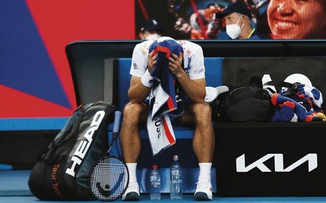 Down two sets to one, a worried Aslan Karatsev takes a break during his first-round match against Jaume Munar.