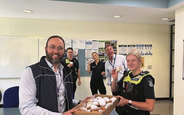 Rabbi Daniel Rabin bringing doughnuts to Oakleigh Police Station over Chanukah.