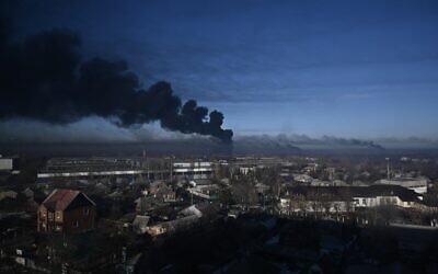 Black smoke rises from a military airport in Chuguyev near Kharkiv on February 24, 2022. Photo: Aris Messinis / AFP