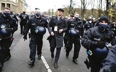 Nikolai Nerling is led away by police during a demonstration against COVID restrictions.Photo: Kay Nietfeld/picture alliance