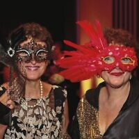 Adele Bern (left), and Andrea Catzel at Emanuel Synagogue's Purim masked ball.