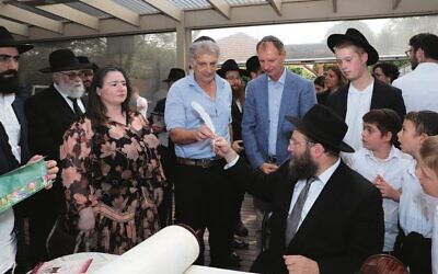 The writing of the final letters in the Sefer Torah.