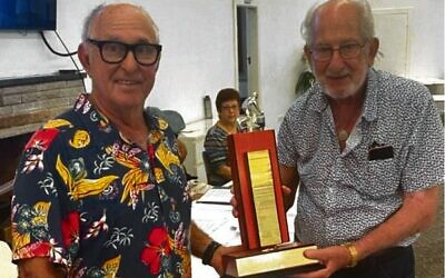 Louis Platus (right) being presented with the Bernie Garden Recognition Award by Shmuel Abrahams.