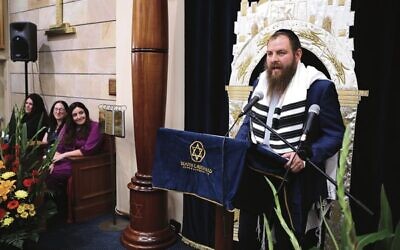 Rabbi Mendy Ajzenszmidt addresses South Caulfield Shule as Rebbetzin Lifshy looks on. Photo: Peter Haskin