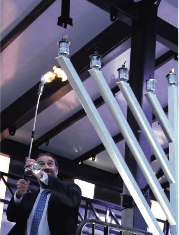 Lighting the Pillars of Light menorah in Federation Square in 2021.