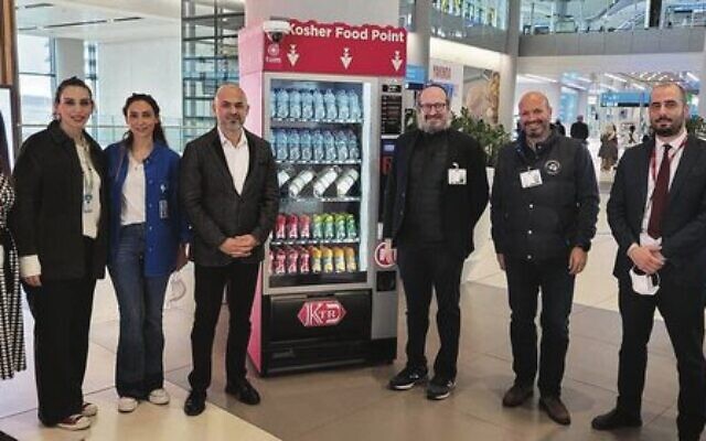 Rabbi Mendy Chitrick (third from right) next to the Istanbul Airport's new kosher vending machine.