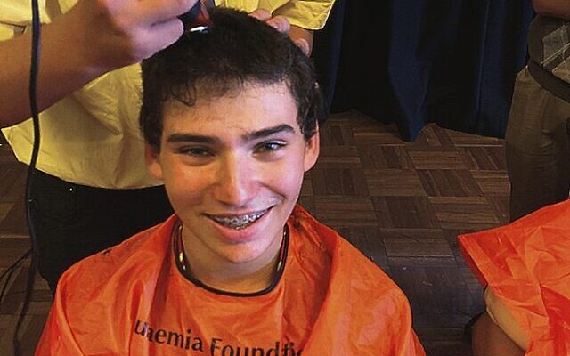 Jesse Lipschitz shaves his head for the ninth consecutive year.