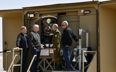 Defense Minister Benny Gantz (second from left) is shown a new laser-based air-defense system at a Rafael weapons manufacturer complex in Israel, March 17, 2022. (Defense Ministry)