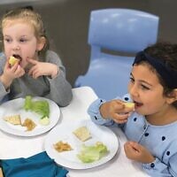 Bella Goldschmiedt (left) and Maayan Meguideche at Kesser Torah College's demo seder.