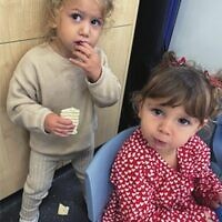 Aryeh Koncepolski (left) and Camilla Leibman try matzah at Kesser Torah College.