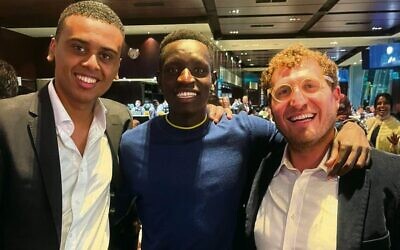 Attendees at the Premier's Iftar dinner from left: Young Victorian of the Year Ahmed Hassan, Olympic athlete Peter Bol, Rabbi Gabi Kaltmann.