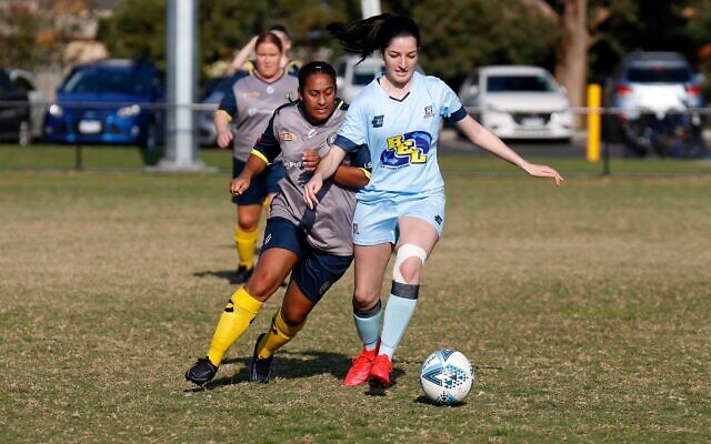 Maccabi FC Caulfield's Aicha Phipps-Booth dribbles ahead of a Noble Hurricanes defender last Sunday at Alex Nelson Reserve, Springvale. Photo: Peter Haskin