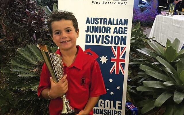 Zac Wolfe holding his 2022 U7 national golf trophy in the Gold Coast last weekend.