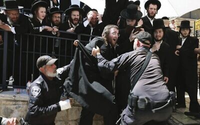 Ultra-Orthodox Jews scuffle with the police as they try to enter the grave site of Rabbi Shimon Bar Yochai in the northern Israeli village of Meron.
Photo: Menahem Kahana/AFP