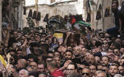 Mourners carry the casket of slain Al Jazeera veteran journalist Shireen Abu Akleh during her funeral in Jerusalem's Old City on May 13, 2022. Photo: AP Photo/Mahmoud Illean
